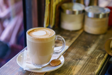 Coffee Latte on wooden table and latte art made with foam