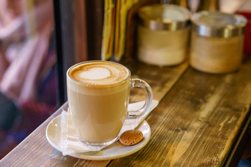 Coffee Latte on wooden table and latte art made with foam