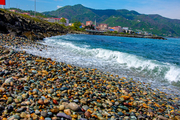 The waves of the Black sea hitting the rocks on the beach in city of Giresun