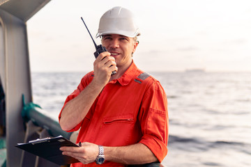 Marine Deck Officer or Chief mate on deck of offshore vessel or ship , wearing PPE personal...