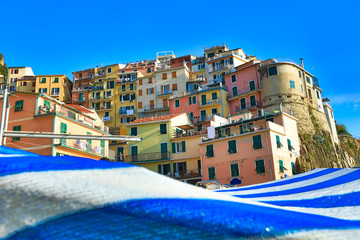 Manarola is one of the five towns in the Cinque Terre region of Italy.  This vacation destination is known for colorful homes on the cliff of the waterfront .