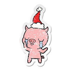 distressed sticker cartoon of a pig crying wearing santa hat