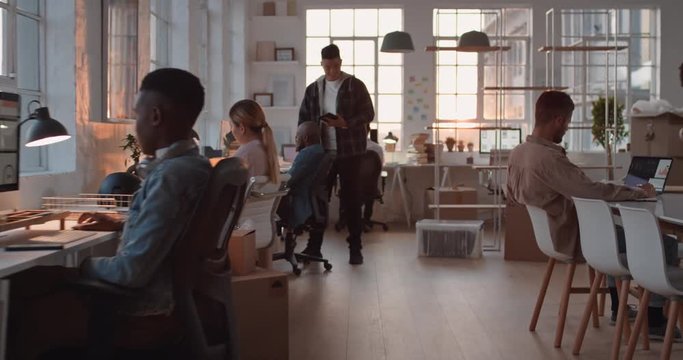 young asian businessman working late software developer meeting client shaking hands collaborating with intern on designing mobile application in office at sunset