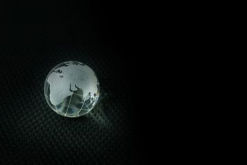 glass ball planet earth in black background.