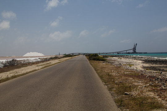 The road to the Salt pier with the conveyor belt on tropical Bonaire island in the caribbean