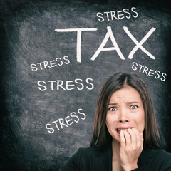 Tax season stress stressed Asian woman biting nails anxious late to file tax paperwork for IRS....