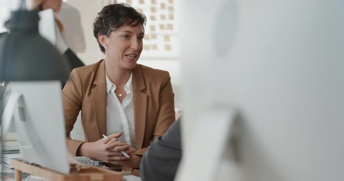 young business woman chatting to intern discussing job interview colleagues having conversation in office enjoying teamwork