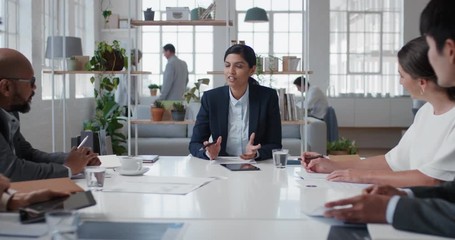 young indian business woman executive meeting corporate leaders discussing development ideas with shareholders brainstorming in office boardroom