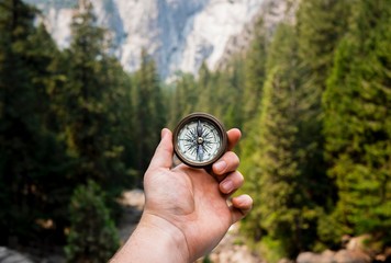 Hand Holding Compass Exploring Mountains © Jamie