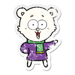 distressed sticker of a laughing teddy  bear cartoon in winter clothes