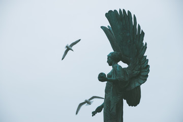 Birds over statue