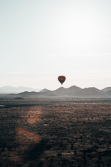 hot air balloon flying over mountains