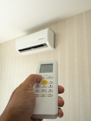 Close up Hand holding Air conditioner remote control