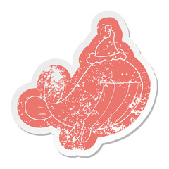 cartoon distressed sticker of a whale wearing santa hat
