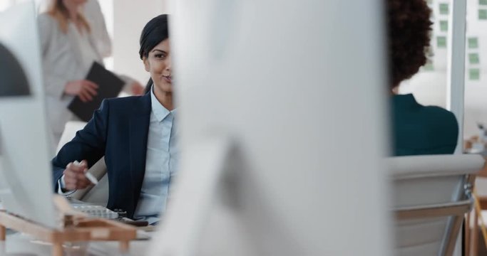 young indian business woman chatting to intern discussing job interview colleagues having conversation in office enjoying teamwork