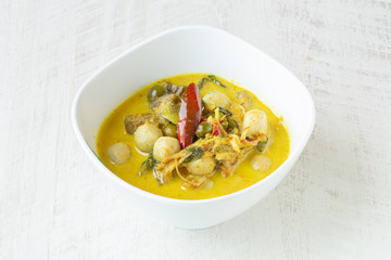 Thai Green Curry with fish balls on white background.