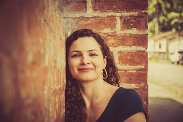 Young girl in front brick wall