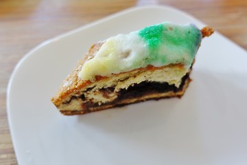 Slice of colorful King's Cake for Mardi-Gras in New Orleans, Louisiana