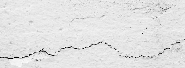 Fototapeta premium black and white, monochrome shot of cracked concrete wall texture for banner background