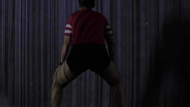 Young woman dancing twerk. striped shadows on a body. Slow motion