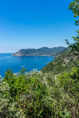 Fototapeta na wymiar Italy, Cinque Terre, Corniglia, a body of water with a mountain in the background