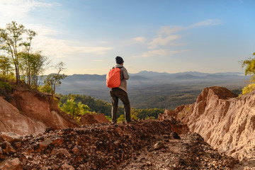 Fototapeta premium Tourist on the peak of high rocks. Sport and active life concept