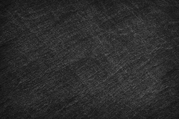 Dark grey / black slate background or texture.