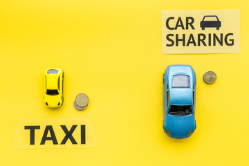 Carsharing vs taxi concept. Comparing carsharing system and taxi. Ship trip concept. Toy cars ans...