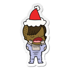 sticker cartoon of a cool hipster girl in space suit wearing santa hat