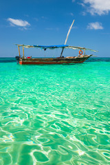 Obraz premium traditional fishing boat in emerald sea on Zanzibar island in Tanzania