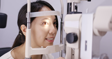 Asian Woman do eye test at clinic
