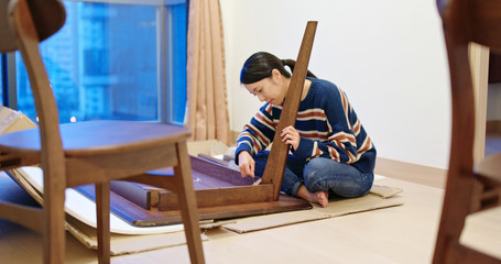 Woman assemble the table at home