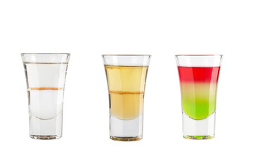 Set of alcohol shots on a white background. Three shots with different types of alcohol.