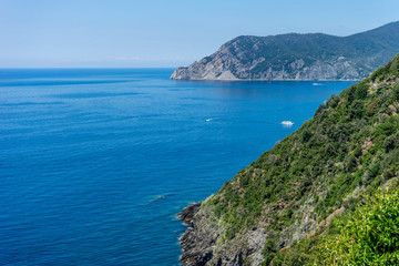Fototapeta premium Italy, Cinque Terre, Corniglia, a body of water with a mountain in the background