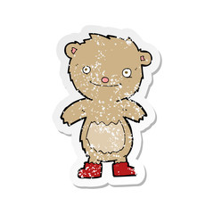 Fototapeta premium retro distressed sticker of a cartoon teddy bear wearing boots