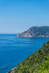 Italy, Cinque Terre, Corniglia, a body of water with a mountain in the background