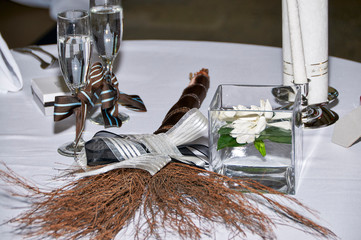 elegant wedding table setting with champagne flutes and jumping broom
