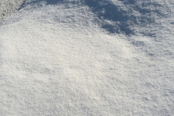 White snow texture on a sunny day. Winter background