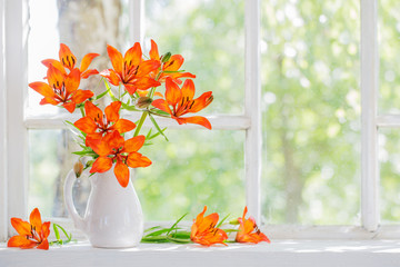 orange lily on windowsill