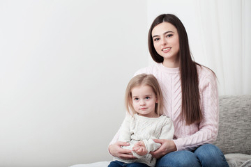 mother and daughter laugh together at home