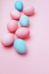 Colored Easter eggs on a pink background. Copy space