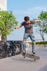 Skateboarder doing a skateboard trick ollie on the street