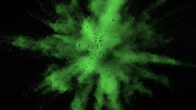 Super slowmotion shot of green powder explosion isolated on black background.