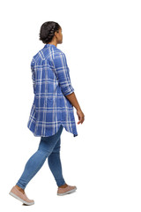 Side view of a young black girl walking in jeans and a checkered shirt.