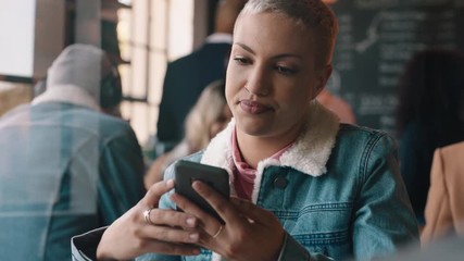 beautiful woman using smartphone in cafe texting sharing messages on social media enjoying mobile technology waiting in busy restaurant