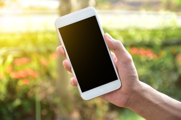 Man holding mobile smart phone using smart application by internet online