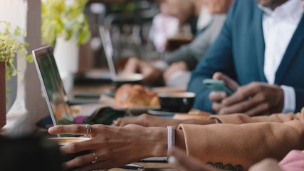 diverse business people hands using laptop computers in busy cafe bustling with activity working online browsing sharing digital email communication