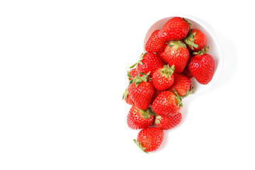Strawberries in a white bowl isolated on white background, side view