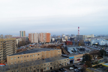 Aerial view of the city district. A wide road passes through the city