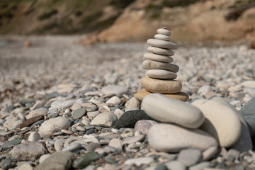 Fototapeta na wymiar Pyramid of pebbles on the beach